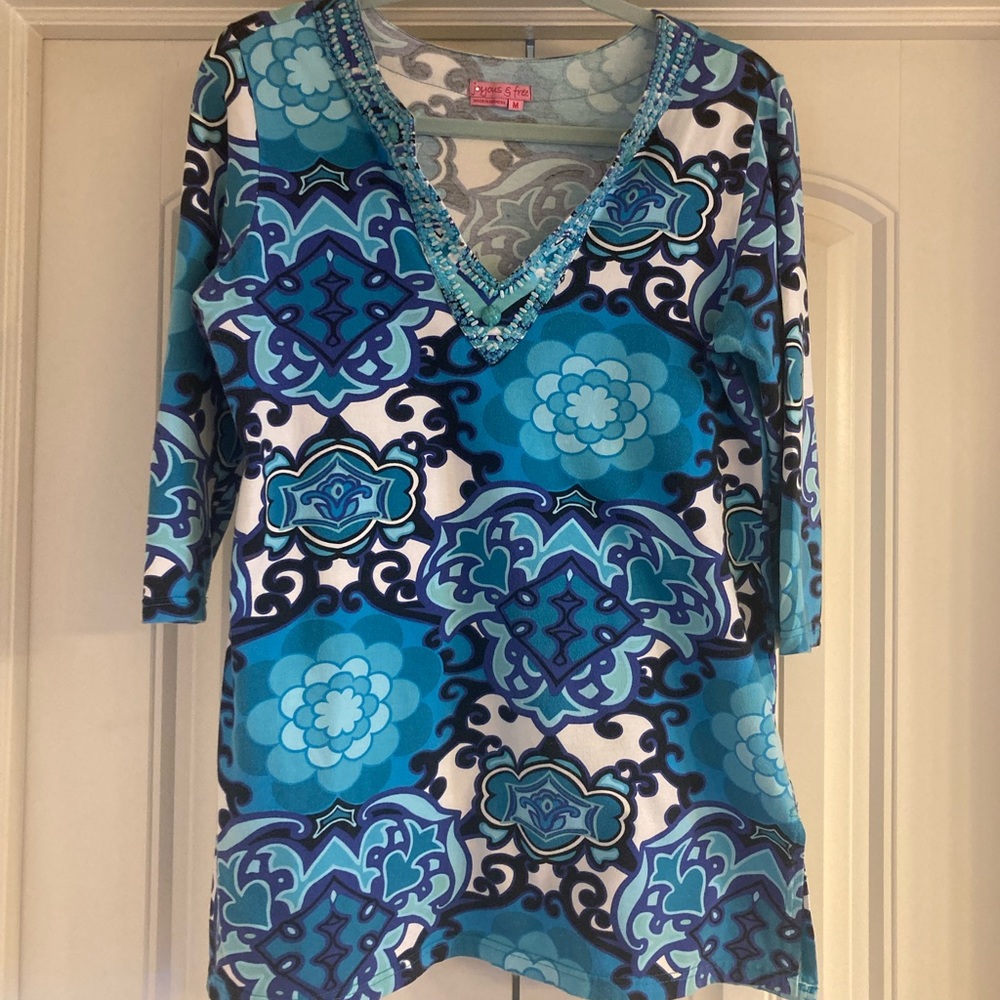 Ladies blue print tunic with beading at neck.
